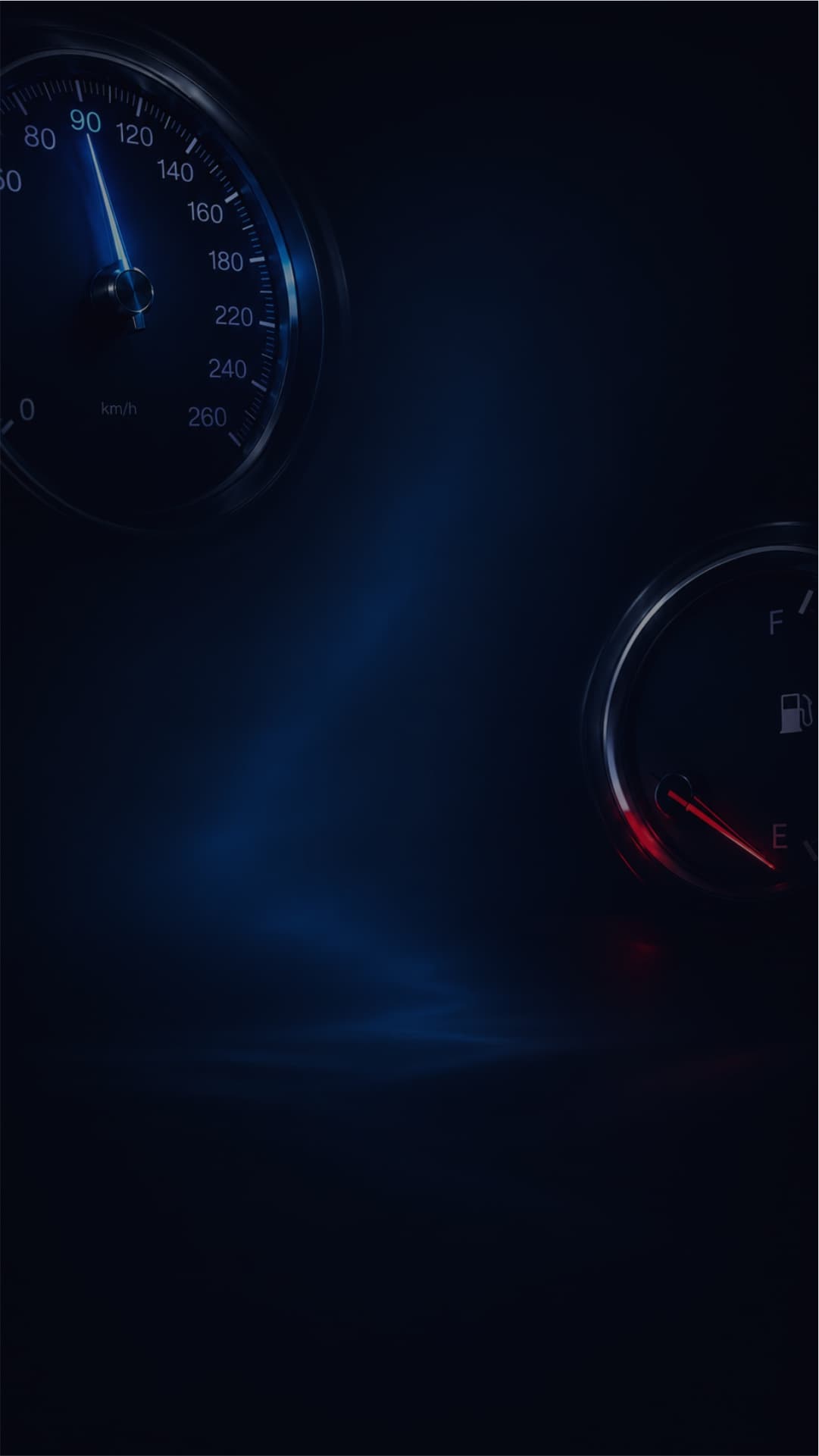 Painel de carro no escuro, com o velocímetro no alto e o marcador de combustível abaixo.